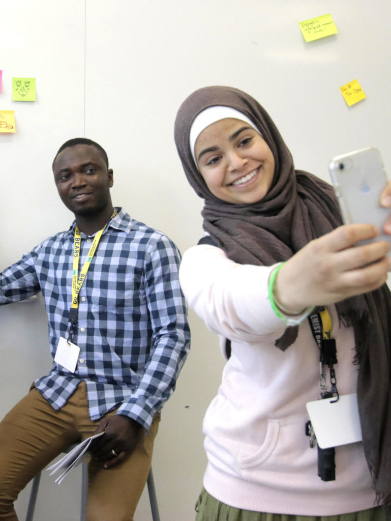 Students take selfie in front of whiteboard