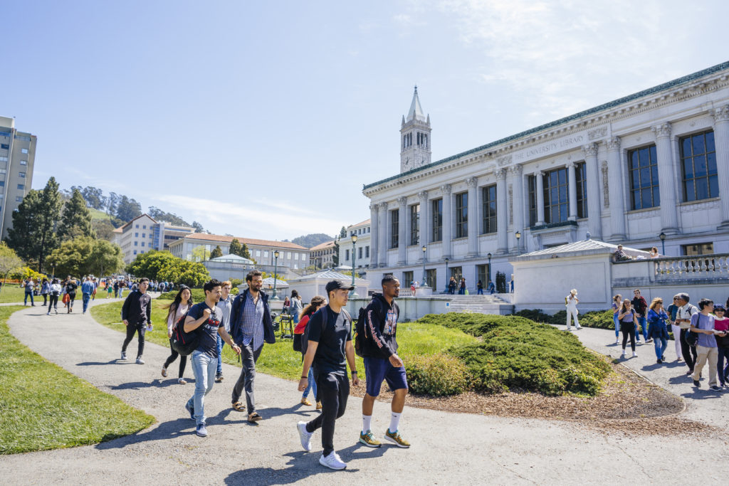 students walking across Cal's campus with Campanile in the background