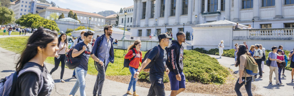 students walking across Cal's campus with Campanile in the background