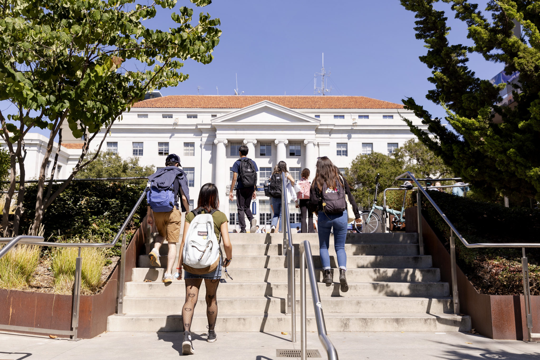 students walking up stairs to Sproul Plaza