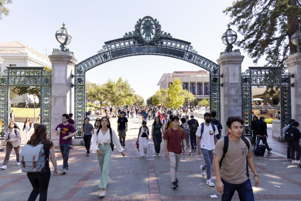 photo of students walking through sather gate