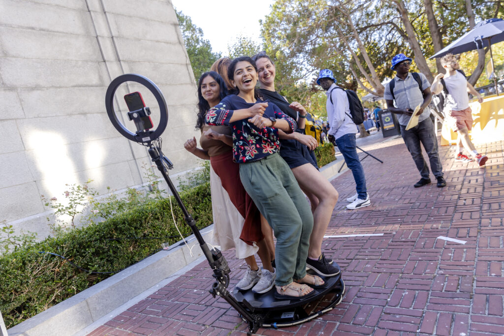 a group of students standing in the 360 photobooth