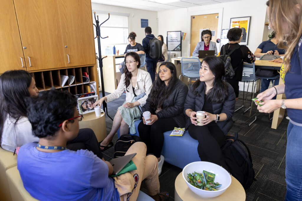 People talking in the Inclusive Excellence Hub Lobby