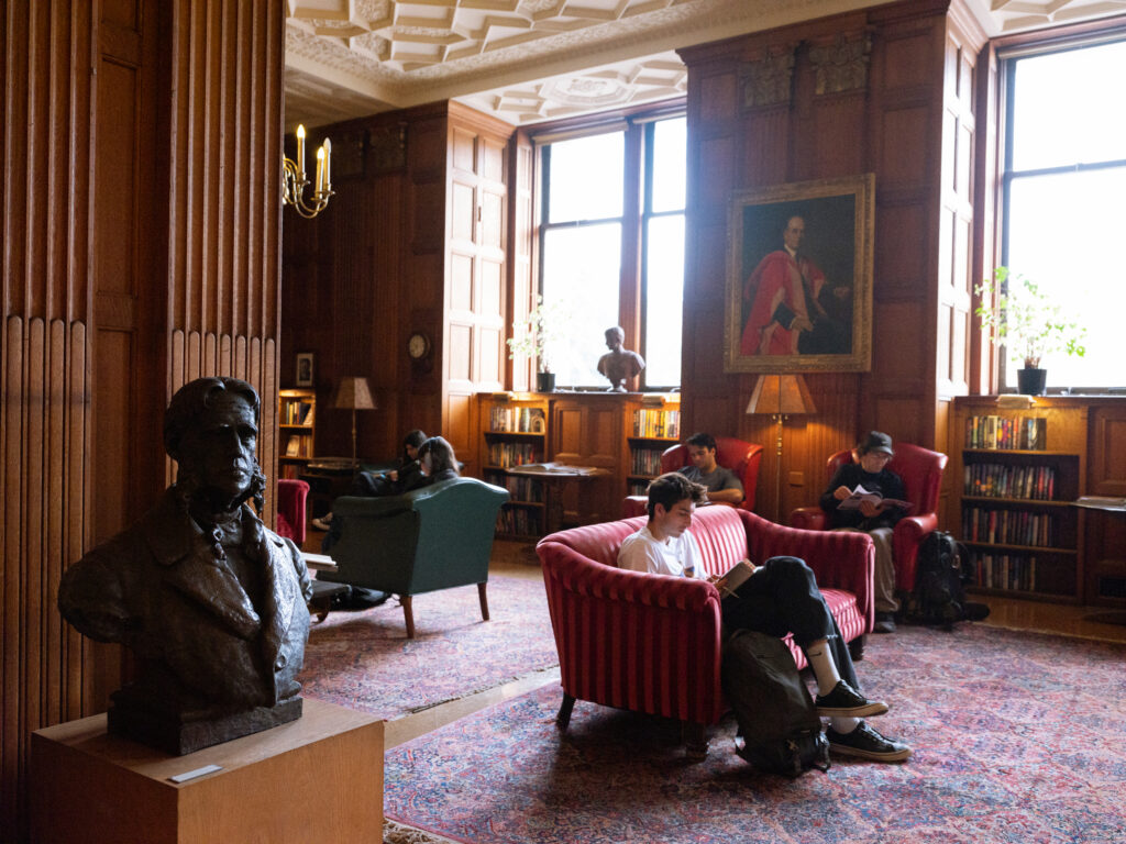 student sitting in chair in library