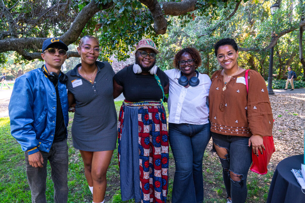 A group of grad students pose together for a photo.