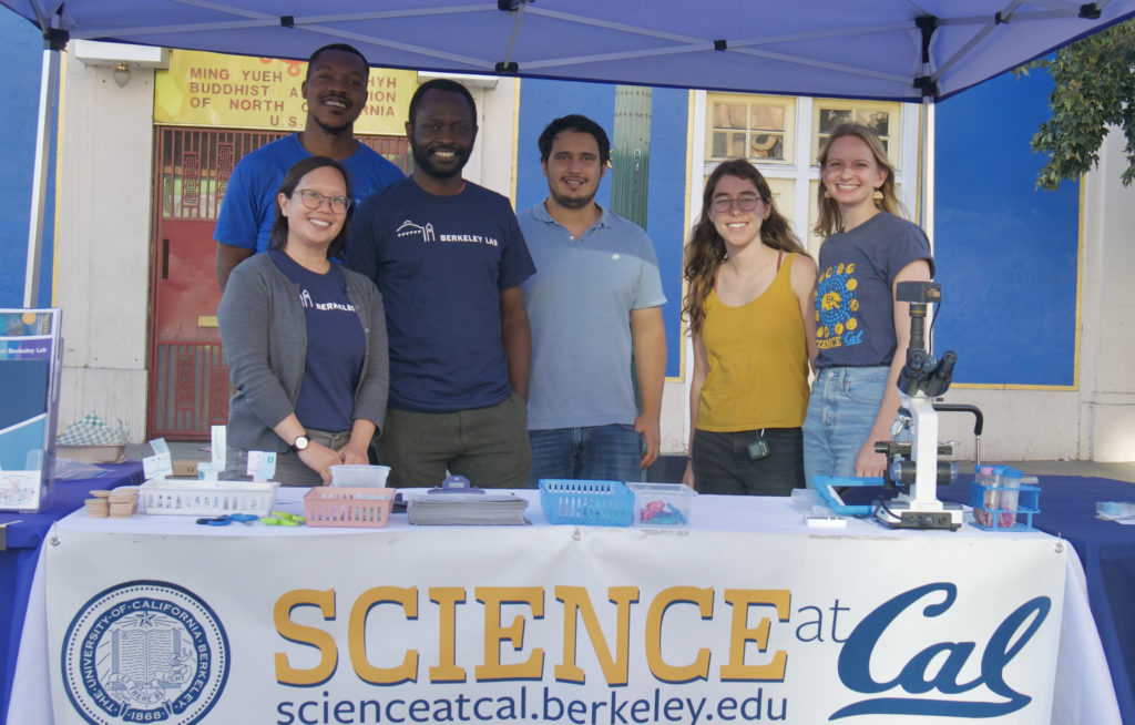 6 Science at Cal student participants standing behind a recruitment table.