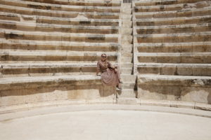 Knutson at an archeological site Amman, Jordan that looks like an ampitheater