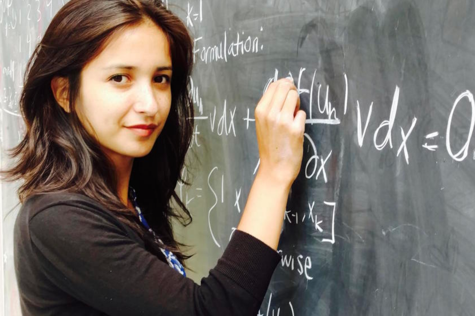 photo of student writing on chalkboard