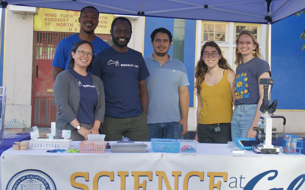 6 Science at Cal student participants standing behind a recruitment table.