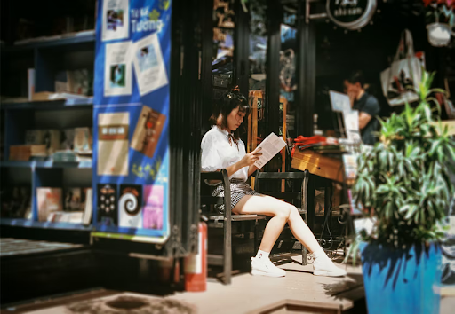 student reading outside of a cafe