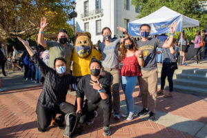 group of Berkeley students standing with Oski the bear