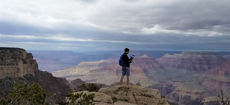Kim Fong stands looking over Grand Canyon