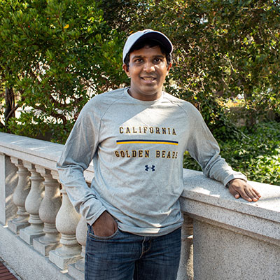 Hari Srinivasan standing against a concrete railing