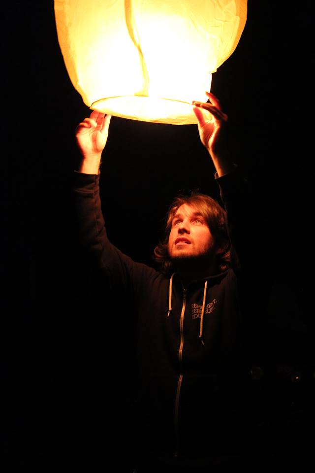 Photo of  Kurtis Heimerl holding a lamp