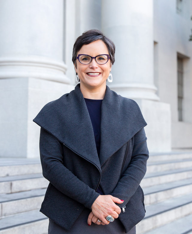 photo of Lisa Garcia Bedolla standing on the steps of Sproul Hall
