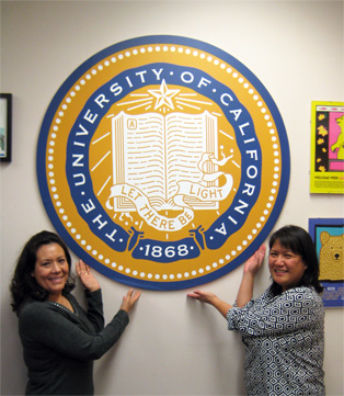 Maria and Gina hold UC seal