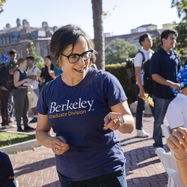 VP for graduate studies Lisa Garcia Bedolla chatting with 2 students at grad-stravaganza