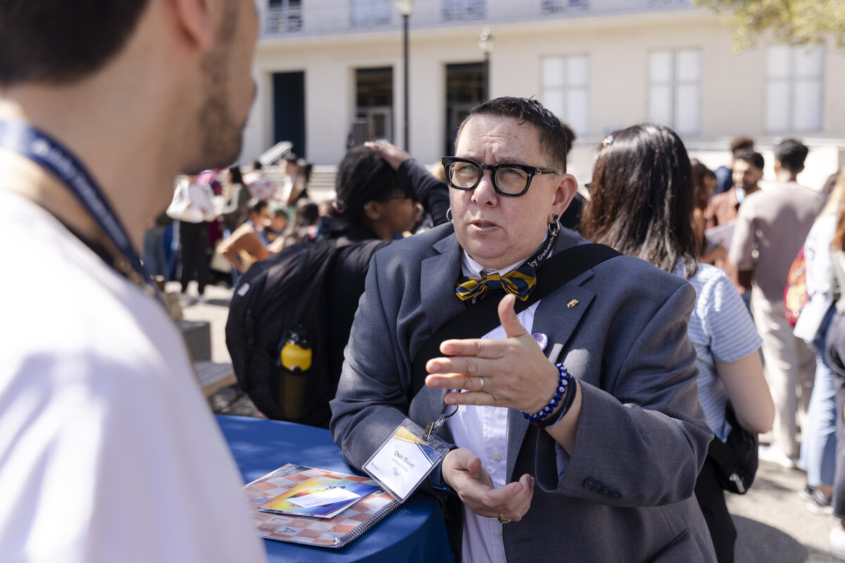 Quin Hussey, AVP for Graduate Students talking one on one with a student outside sproul hall.