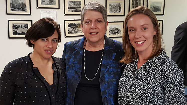 Photo of Janet Napolitano posing with two students
