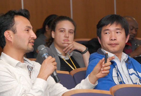 Graduate students ask questions at the Town Hall