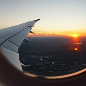 image looking out onto an airplane wing from inside the plane